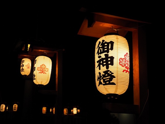 「御神燈」と記された提灯が夜の闇に灯る
